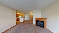 Located at 6120 Westwood Pkwy in Saint Cloud, Minnesota, this 2-bedroom, 1-bathroom residence offers a well-organized, single-floor layout designed for comfortable everyday living. The open-concept living, dining, and kitchen area forms the heart of the home, anchored by a warm wood-manteled corner fireplace and carpeted flooring throughout. Natural light filters in through multiple windows and a glass-paneled exterior door, creating a bright and welcoming atmosphere. Baseboard heating is present throughout the living spaces. The kitchen is outfitted with warm oak cabinetry, ample counter space, a double-basin sink, and white appliances including a refrigerator, range, microwave, and dishwasher. Light tile flooring adds a clean, functional touch to this space. The generously sized primary bedroom includes a double-door closet, carpeted floors, and a ceiling light fixture. The second bedroom also features carpeted floors and a bright window with outdoor views. Four closets throughout the unit provide abundant storage. The full bathroom includes a combination tub and shower with chrome fixtures. A dedicated laundry area houses a full-size washer and dryer with overhead shelving, adding everyday convenience to this practical and comfortable home.