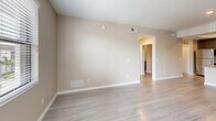 Located at Cypress Gardens Loop in Fort Myers, Florida, this single-floor, three-bedroom, two-bathroom unit offers a well-organized layout with a cohesive, modern aesthetic. The open-concept kitchen and living area serves as the heart of the home, featuring dark espresso cabinetry, granite countertops, a subway tile backsplash, a stainless steel appliance suite, and a peninsula with a built-in sink — all beneath a distinctive tray ceiling that adds architectural interest. Light wood-style flooring flows throughout the main living areas, complementing the warm neutral wall tones and crisp white trim. The spacious primary bedroom includes direct access to a private balcony and connects to a dedicated en-suite bathroom equipped with a walk-in tiled shower, granite vanity, and dark wood cabinetry. A walk-in closet with wire shelving provides generous storage. The secondary bathroom features a full tub-shower combo with white tile surround. The two additional bedrooms are bright and well-proportioned, each with natural light from windows with blinds. A pantry and hallway closet offer added storage convenience, making this a highly functional and thoughtfully designed residential unit.