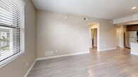 Located at Cypress Gardens Loop in Fort Myers, Florida, this single-floor, three-bedroom, two-bathroom unit offers a well-organized layout with a cohesive, modern aesthetic. The open-concept kitchen and living area serves as the heart of the home, featuring dark espresso cabinetry, granite countertops, a subway tile backsplash, a stainless steel appliance suite, and a peninsula with a built-in sink — all beneath a distinctive tray ceiling that adds architectural interest. Light wood-style flooring flows throughout the main living areas, complementing the warm neutral wall tones and crisp white trim. The spacious primary bedroom includes direct access to a private balcony and connects to a dedicated en-suite bathroom equipped with a walk-in tiled shower, granite vanity, and dark wood cabinetry. A walk-in closet with wire shelving provides generous storage. The secondary bathroom features a full tub-shower combo with white tile surround. The two additional bedrooms are bright and well-proportioned, each with natural light from windows with blinds. A pantry and hallway closet offer added storage convenience, making this a highly functional and thoughtfully designed residential unit.