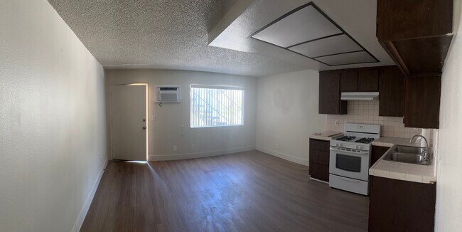 Front door, living room and kitchen - 200 S Carondelet St