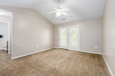 Located at 679 Covered Bridge Pkwy in Prattville, Alabama, this single-story residence offers two bedrooms and two bathrooms within a thoughtfully arranged floor plan. The living area features vaulted ceilings with a ceiling fan and access to an outdoor area through a glass door, allowing natural light to fill the space. Neutral-toned walls and soft carpeting run throughout the living and bedroom areas, creating a cohesive and comfortable atmosphere. The kitchen is designed with a pass-through bar layout, featuring warm wood cabinetry, dark countertops, and stainless steel appliances, including a refrigerator and microwave. A pendant light over the bar area adds a decorative touch. The spacious primary bedroom is generously sized and includes access to an outdoor patio, offering a private retreat. The second bedroom is well-proportioned, carpeted, and includes a closet with classic paneled doors and a window overlooking the surrounding greenery. Both bathrooms feature warm wood-tone cabinetry, dark countertops, single-basin sinks, and wood-look flooring. One bathroom includes a tub-shower combination. The overall design is clean, neutral, and move-in ready.