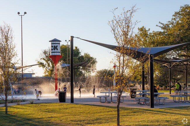 The Maxey Park community cools off in the splash pad at its namesake park.