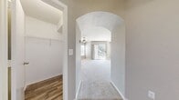This 730 square foot, single-story apartment in Orlando offers a thoughtful blend of comfort and style. The space features a generous 170 square foot primary bedroom, complemented by a well-appointed bathroom with a modern vanity and tub-shower combination. The heart of the home is an open-concept living area that seamlessly integrates the kitchen, dining, and living spaces. The kitchen boasts white cabinetry, stainless steel appliances, and a convenient island, perfect for casual dining or entertaining. Natural light floods the space through multiple windows, including a sliding glass door that leads to a private balcony with pool views. The apartment showcases a neutral color palette with light gray walls and plush carpeting in the bedroom and living areas, while the kitchen and bathroom feature durable wood-look flooring. Additional amenities include a ceiling fan, ample closet space, and built-in shelving, enhancing both the functionality and aesthetic appeal of this modern urban dwelling.