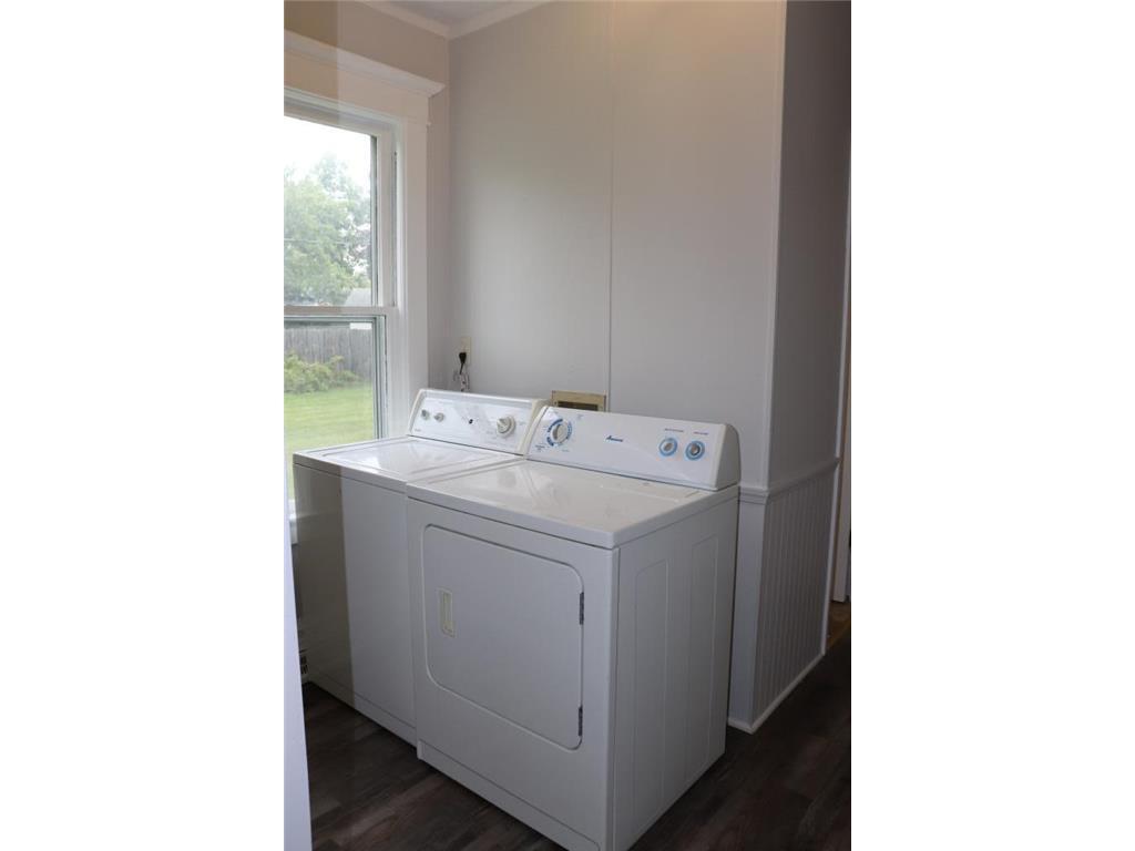 Main level laundry room with built in storage space. - 302 19 1/2 Ave N