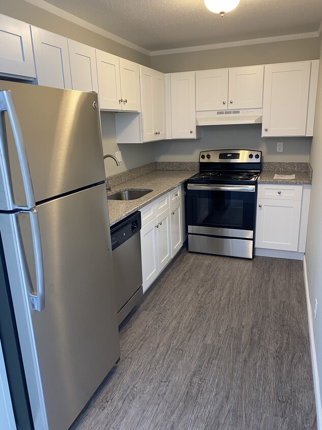 The kitchen features brand new stainless steel appliances, granite countertops & new shaker cabinets - 875 Branch Rd