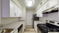 Located at 99 Antelope Way in Worthington, Ohio, this single-floor residence offers a thoughtfully designed layout with modern updates throughout. The galley-style kitchen is a standout feature, showcasing white shaker cabinetry, granite-look countertops, a subway tile backsplash, and stainless steel appliances, including a refrigerator and range. Wood-look luxury vinyl plank flooring runs through the kitchen and living areas, lending a clean, cohesive aesthetic. A peninsula with a sink connects the kitchen to the open living space, which is bathed in natural light from a large sliding glass door that opens to an outdoor area with vertical blinds for privacy. The bedrooms feature neutral carpet, ample natural light from windows, and generous closet space — one bedroom includes a walk-in closet with built-in shelving. Two bathrooms serve the home; one features a wide vanity with white cabinetry and a large mirror, while the second offers a similarly clean design with a tub-shower combo. Throughout the space, neutral warm tones, crisp white trim, and consistent finishes create a bright, move-in-ready atmosphere well-suited for comfortable everyday living.