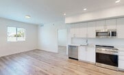 Located at 18355 SW 110th Ave in Miami, FL, this single-story, 2-bedroom, 2-bathroom unit offers a thoughtfully designed open-concept layout with modern finishes. Light wood-look flooring runs throughout, complementing the crisp white walls and recessed lighting that create a bright, clean aesthetic.

The open living and dining area flows seamlessly into the kitchen, which is equipped with stainless steel appliances — including a French door refrigerator with ice maker, gas range, built-in microwave, and dishwasher — alongside sleek white flat-front cabinetry and a undermount sink.

The primary bedroom is a comfortable, well-proportioned retreat featuring a ceiling fan and a window with blinds for natural light. The second bedroom is equally bright and versatile. Both rooms offer ample closet storage, with four closets total throughout the unit.

The two bathrooms are finished in neutral tile with white vanities, undermount sinks, and large mirrors. One bathroom features a shower/tub combination with tile surround, while the other offers a more streamlined layout.

Additional highlights include a dedicated laundry area, a utility room, and convenient entry access. The layout is efficient and well-organized, making excellent use of its footprint in a clean, contemporary style.