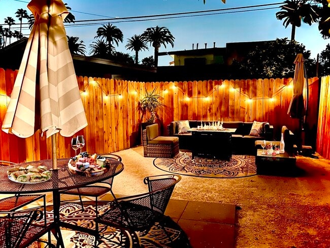 Gather and relax around the fire pit table. - 2824 S Orange Dr