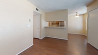 Located at 5020 Fairbanks Dr in El Paso, Texas, this single-floor residence offers a practical and well-organized layout. The living area greets you at the entry, finished with rich hardwood-style flooring and a large window fitted with blinds that allows natural light to fill the space. A textured ceiling and ceiling fan add functional character throughout the common areas.

The kitchen is designed as a galley-style space, featuring warm oak cabinetry that extends to the upper and lower levels, providing generous storage. A stainless steel refrigerator and oven anchor the room, complemented by a double-basin sink and ample counter space. A pass-through opening connects the kitchen directly to the living area, promoting an open and connected feel. A dedicated pantry closet is also accessible from within the kitchen.

The bedrooms are carpeted in a neutral tone, offering a comfortable and quiet retreat. Each room benefits from natural light through windows with blinds, and the clean, warm wall tones carry consistently throughout the home, creating a cohesive aesthetic.

The bathroom includes a full-size tub and shower combination with chrome fixtures, set against clean white surroundings. Overall, this residence presents a straightforward, functional design with consistent finishes throughout, well-suited for comfortable everyday living in the northeast El Paso area.