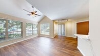 This contemporary 680 square foot apartment offers a perfect blend of comfort and style. The open-concept living area is anchored by a charming fireplace, providing a focal point for relaxation and entertainment. Large windows throughout allow ample natural light to illuminate the space, creating an airy and welcoming ambiance.

The kitchen is a highlight, featuring sleek white cabinetry, stainless steel appliances, and a convenient breakfast bar. The modern design extends to the bathroom, which boasts a stylish vanity and updated fixtures.

Both bedrooms are generously sized, with the primary bedroom measuring 140 square feet. Each room is equipped with ample closet space and ceiling fans for added comfort. The rich, warm-toned hardwood floors unify the entire apartment, adding a touch of elegance to every room.

Additional features include window blinds for privacy, a ceiling fan in the living area, and a layout that maximizes the use of space. The apartment's single floor design ensures easy accessibility, making it an ideal choice for various lifestyles. With its thoughtful design and modern amenities, this apartment offers a comfortable and contemporary living experience.