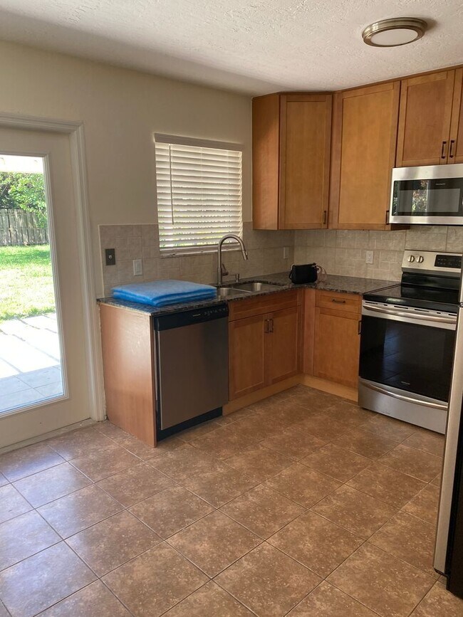 Building Photo - 2/2/1 home with a spacious fenced backyard...