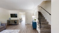 Located at 8317 Severn Orchard Circle in Severn, Maryland, this two-story home offers a well-organized layout across two floors. The main level features light wood-style flooring that flows seamlessly through the living room, dining area, and kitchen. The living room is a welcoming space filled with natural light from vertical-blind-covered windows. Adjacent to it, the dining area accommodates a full-sized table and benefits from sliding door access, bringing in additional light. The kitchen is equipped with warm oak cabinetry, a gas range, dishwasher, and ample counter space, reflecting a functional and practical design. A carpeted staircase with a railing leads to the upper level, where all three bedrooms are located. The spacious primary bedroom features natural light from a window with curtains and offers generous floor space. The two additional bedrooms are cozy and well-proportioned, each with windows that allow natural light in. The shared full bathroom features white subway tile surround, a tub-shower combination, a single vanity, and a window for ventilation. Throughout the home, a consistent neutral color palette and light wood flooring create a cohesive and inviting atmosphere.