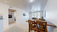 Located at 700 Comet Ln in Lawrence, Kansas, this single-floor, one-bedroom, one-bathroom unit offers a practical and comfortable layout across a well-utilized footprint. The open-concept living and dining area serves as the heart of the home, featuring plush carpeting, a ceiling fan, and a large multi-pane window that invites abundant natural light. The space comfortably accommodates both a full dining set and a living area, with a wall-mounted TV adding a modern touch. A glass-paned door provides additional light and access to the outdoors.

The kitchen is accessed via a peninsula-style breakfast bar that connects seamlessly to the main living space. It features white cabinetry, neutral countertops, tile flooring, and white appliances including a dishwasher, stove, microwave, and refrigerator — offering full functionality in an efficient layout.

The bedroom is a well-proportioned, carpeted retreat with a large window overlooking the exterior, providing natural light and a connection to the outdoors. A dedicated closet adds practical storage.

The full bathroom includes a tub/shower combination with a sliding glass enclosure, a white vanity with storage, and tile flooring. A separate laundry room houses a washer and dryer alongside the home's HVAC system, adding everyday convenience to this thoughtfully arranged residence.