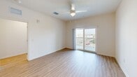 This contemporary apartment in Fort Myers, FL, offers 1130 square feet of well-designed living space. The single-story layout includes three bedrooms, four bathrooms, and a combined kitchen and living area. The primary bedroom, measuring 180 square feet, provides ample space for comfort.

The interior showcases a modern aesthetic with clean lines and a neutral color palette. Light-toned wood flooring runs throughout, complementing the crisp white walls and creating a bright, airy atmosphere. The kitchen boasts sleek cabinetry, granite countertops, and stainless steel appliances, including a built-in microwave and refrigerator.

Large windows and sliding glass doors allow natural light to flood the space, while a private balcony offers outdoor views. The bathrooms feature modern fixtures, including glass-enclosed showers with rainfall showerheads. A dedicated laundry room with stacked washer and dryer adds convenience.

The apartment's open floor plan and minimalist design promote a sense of spaciousness, making it ideal for both relaxation and entertainment. Located at 3700 Wolf Liam Dr., this property combines style and functionality in a desirable Florida location.