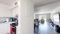 Located in Hollywood, Florida, this 2-bedroom, 1-bathroom residence offers a functional and comfortable single-floor layout. The open-concept living and dining area is bright and welcoming, featuring light wood-look laminate flooring that runs throughout the home. The living room benefits from a large sliding glass door that opens to a private balcony, flooding the space with natural light and offering pleasant outdoor views of the surrounding greenery. A dedicated dining area sits adjacent to the living room, creating a seamless flow ideal for everyday living and entertaining.

The kitchen features light-toned cabinetry and is complemented by a window that brings in additional natural light. The spacious primary bedroom is generously sized, offering ample room with large louver-door closets and a window with vertical blinds. The second bedroom is equally well-lit, featuring its own closet, wall-mounted TV, and access to natural light. Both bedrooms continue the wood-look flooring found throughout the home.

The bathroom is cleanly finished with white tile flooring and wall tiling, a vanity with mirror, and a glass-door walk-in shower. A hallway connects the main living areas to the bedrooms, completing this well-organized and comfortable layout in a convenient Hollywood location.