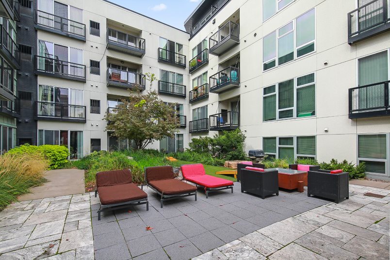 Courtyard seating area with lounge chairs and outdoor furniture