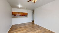 Located at 600 Texas St in Denton, TX, this single-story, one-bedroom, one-bathroom unit offers a practical and well-laid-out floor plan with consistent wood-look flooring throughout. The open living area is bright and inviting, featuring a ceiling fan with light fixture, clean white walls, and a window that allows natural light to filter in. A front entry door with an adjacent window further enhances the airy feel of the main living space.

The kitchen is designed in a galley style, lined on both sides with warm honey-toned wood cabinetry and light countertops. It is equipped with a white electric range and a double-basin stainless steel sink, with upper and lower cabinets providing ample storage. A pass-through countertop connects the kitchen to the living area, creating a sense of openness between the two spaces.

The bedroom is a comfortable size, featuring its own ceiling fan, a window with blinds offering natural light and privacy, and a closet for dedicated storage. The bathroom continues the wood-look flooring and includes a wood-toned vanity with storage, a mirrored medicine cabinet, a lighted vanity bar, and matching upper cabinetry. The layout is efficient and functional throughout, making this a well-appointed unit suited for straightforward, comfortable living.
