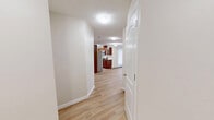 Located at 30 Nevada Place in St. Albert, Alberta, this well-designed two-bedroom, two-bathroom unit offers a functional and comfortable single-floor layout. Light wood laminate flooring flows consistently throughout the main living areas, complementing the neutral, warm-toned walls and creating a bright, cohesive aesthetic.

The kitchen is a standout feature, showcasing rich dark wood cabinetry, granite countertops, a subway tile backsplash, and a full suite of stainless steel appliances including a dishwasher, electric range with hood, and refrigerator. The open living area adjoins the kitchen, offering a spacious, airy feel with ample natural light filtering through generously sized windows.

Both bedrooms are well-proportioned, each featuring large windows that bring in natural light and views of the surrounding neighbourhood. The primary bedroom includes a dedicated closet with double doors, providing practical storage. Baseboard heating is present throughout.

The two bathrooms are distinctly configured: one features a full tub-shower combination with white tile surround, while the second offers a walk-in glass-door shower alongside a vanity with granite countertop and dark wood cabinetry. Both bathrooms are finished with light ceramic tile flooring. A hallway connects the private areas of the unit, completing this practical and well-maintained layout.