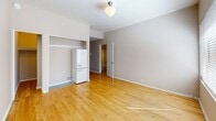 Located at 403, 1103-1117 SW Alder St in the heart of Portland, Oregon, this studio unit offers an efficient and thoughtfully organized single-floor layout. The combined kitchen and living area serves as the central space of the unit, featuring warm-toned hardwood flooring that runs throughout and neutral, light-toned walls that contribute to a bright and airy ambiance. A wide window fitted with horizontal blinds allows natural light to pour into the living area, complemented by a classic globe pendant light fixture overhead. The kitchen is equipped with white cabinetry, a full-size range, and a refrigerator set within a built-in nook, making practical use of the available space. A dedicated closet provides convenient storage. The bathroom is cleanly finished with white subway tile surrounding a soaking tub and shower combination, a pedestal sink with brushed nickel fixtures, an oval mirror, and light wood-toned flooring, creating a crisp and functional space. Throughout the unit, clean white trim and baseboards frame each room, adding a polished, cohesive look. The overall design is simple and functional, well-suited for urban living in one of Portland's central neighborhoods.