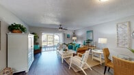 Located at 1400 Donegan Ave in Kissimmee, FL, this single-floor, one-bedroom, one-bathroom residence offers a thoughtfully designed layout with a warm coastal aesthetic. Wood-style flooring runs throughout, tying each room together seamlessly.

The entrance hallway provides a welcoming introduction to the home, leading into a bright and open combined living and dining area. The living space features a ceiling fan, textured ceiling, and sliding glass doors that open to a private patio, filling the room with natural light and offering easy outdoor access.

The galley-style kitchen is efficiently arranged with ample white cabinetry, light countertops, full appliances including a range and refrigerator, a double sink, and a dedicated pantry for extra storage.

The bedroom is a comfortable, well-proportioned retreat complete with a ceiling fan, a large window that invites natural light, and built-in closet space. The full bathroom includes a tub/shower combination, a vanity with granite-style countertops, and a large mirror.

Additional features include a utility room, multiple closets for storage, and a hallway connecting the main living areas. The layout is practical and efficient, making excellent use of its available square footage.