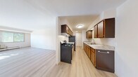 Located at 1674 Shawano Ave in Green Bay, Wisconsin, this one-bedroom, one-bathroom unit offers a well-organized and functional single-floor layout. Light wood-tone flooring runs throughout the main living areas, creating a clean, cohesive aesthetic.

The galley-style kitchen is efficiently designed with warm-toned wood cabinetry on both sides, granite-look countertops, a stainless steel sink, a gas range with overhead ventilation, a dishwasher, and a full-size refrigerator — providing ample workspace and storage for everyday cooking. The kitchen opens directly into a combined dining and living area, offering a connected, open feel. The family room is generously proportioned, bathed in natural light through a large multi-pane window with views of mature trees, and features baseboard heating and a wall-mounted A/C unit.

The bedroom is a comfortable retreat, finished with soft carpeting, a window overlooking the outdoors, baseboard heating, and a wide double-door closet providing substantial storage. A hallway connects the living spaces to the full bathroom, which features a white-tiled tub-shower combination, a vanity, and light wood-tone flooring. Two closets throughout the unit offer additional organizational convenience.