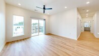 Located at 660 Dickerson Pike in Nashville, TN, this modern 2-bedroom, 2-bathroom residence offers a well-designed single-floor layout with contemporary finishes throughout. Light-toned hardwood flooring flows seamlessly through every room, complementing the clean, bright aesthetic of the space.

The open-concept kitchen and living area serves as the heart of the home. The kitchen is outfitted with gray flat-front cabinetry, a light blue island with a white quartz countertop, stainless steel appliances including a full-size refrigerator, built-in microwave, gas range, and dishwasher, and a crisp white tile backsplash. The adjacent living area is bright and airy, featuring recessed lighting, a ceiling fan, and sliding glass doors that open to a private balcony overlooking the landscaped courtyard.

Both bedrooms are comfortably sized, featuring ceiling fans, natural light from windows with blinds, and clean white walls. The primary bedroom includes a spacious double-door closet with matte black hardware. Each bathroom is finished with gray vanity cabinetry, white quartz countertops, large wall mirrors, and light wood-tone flooring. One bathroom features a tub-shower combination with white subway tile surround. The balcony provides open views of the surrounding Nashville neighborhood.
