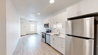 Located at 305 Fifth Ave S in Saint Cloud, Minnesota, this one-bedroom, one-bathroom unit offers a thoughtfully designed layout across a single floor. The open-concept kitchen and living area serves as the heart of the space, featuring a sleek, modern kitchen outfitted with white flat-panel cabinetry, light countertops, stainless steel appliances including a refrigerator, range, microwave, and dishwasher, and recessed lighting overhead. Light wood-look flooring runs consistently throughout the main areas, enhancing the bright and cohesive feel of the space. The bedroom is a well-proportioned room bathed in natural light from a window with views of the surrounding neighborhood, complemented by clean white walls and the same warm flooring. The full bathroom includes a single-sink vanity with ample cabinet storage, a full tub-shower combination, and light-toned tile flooring, maintaining the clean, neutral aesthetic found throughout the unit. White walls and updated finishes give the entire space a fresh, contemporary character. Situated in downtown Saint Cloud, this unit offers convenient access to local amenities, dining, and services in the heart of the city.