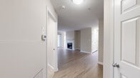 This single-floor residence offers a thoughtfully designed layout with a neutral color palette, creating a clean and welcoming atmosphere throughout. The open entryway leads into a spacious living area finished with warm hardwood-style flooring and crisp white trim. A standout feature of the living room is the tile-surround fireplace, which serves as an inviting focal point. Large windows allow natural light to flow freely into the space, enhancing its bright and airy feel.

The kitchen is well-equipped with rich dark wood cabinetry offering generous storage, stainless steel appliances including a gas range, microwave, and refrigerator, and a granite countertop peninsula that doubles as a breakfast bar. A single-basin sink with a modern faucet completes the functional workspace.

The bedrooms are finished with plush carpeting and feature windows that bring in natural outdoor views, contributing to a comfortable and relaxed atmosphere. Closet access is conveniently located within the bedroom areas.

The bathrooms are finished consistently with granite-topped vanities featuring warm wood cabinetry, large mirrors, and full tub-shower combinations with tile surrounds and chrome fixtures. The tile flooring adds a polished, cohesive touch throughout the bathrooms. Overall, the space delivers a balance of comfort and practicality with quality finishes.