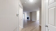 This single-floor residence offers a thoughtfully designed layout with a neutral color palette, creating a clean and welcoming atmosphere throughout. The open entryway leads into a spacious living area finished with warm hardwood-style flooring and crisp white trim. A standout feature of the living room is the tile-surround fireplace, which serves as an inviting focal point. Large windows allow natural light to flow freely into the space, enhancing its bright and airy feel.

The kitchen is well-equipped with rich dark wood cabinetry offering generous storage, stainless steel appliances including a gas range, microwave, and refrigerator, and a granite countertop peninsula that doubles as a breakfast bar. A single-basin sink with a modern faucet completes the functional workspace.

The bedrooms are finished with plush carpeting and feature windows that bring in natural outdoor views, contributing to a comfortable and relaxed atmosphere. Closet access is conveniently located within the bedroom areas.

The bathrooms are finished consistently with granite-topped vanities featuring warm wood cabinetry, large mirrors, and full tub-shower combinations with tile surrounds and chrome fixtures. The tile flooring adds a polished, cohesive touch throughout the bathrooms. Overall, the space delivers a balance of comfort and practicality with quality finishes.