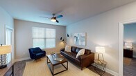 This single-floor, 2-bedroom, 2-bathroom residence offers a thoughtfully designed layout with contemporary finishes throughout. The open-concept living area features wood-style flooring, neutral tones, and large windows with blinds that allow ample natural light to fill the space. A ceiling fan adds both comfort and style to the living room, which is spacious enough to accommodate a full seating arrangement.

The kitchen is a standout feature, showcasing rich dark cabinetry, granite countertops, a subway tile backsplash, and a full suite of stainless steel appliances. A generous island with seating provides an ideal space for dining or casual entertaining.

Both bedrooms are well-sized, each equipped with ceiling fans, wood-style flooring, and windows that bring in natural light. The primary bedroom connects to a bathroom offering a walk-in shower with built-in shelving and a separate soaking tub. A spacious walk-in closet with multi-tiered shelving provides excellent storage. The second bedroom offers versatility, functioning equally well as a guest room or home office.

The second full bathroom maintains the same clean, modern aesthetic. Throughout the unit, the consistent use of neutral colors, wood-style flooring, and modern fixtures creates a cohesive and inviting atmosphere.