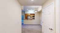 Located at 2000 Villa Dr in Pittsburg, CA, this well-designed 2-bedroom, 2-bathroom residence offers a comfortable and functional single-floor layout. The open-concept living and dining area is highlighted by plush carpeting, a ceiling fan, and sliding glass doors that lead to a private balcony, filling the space with natural light. A tiled fireplace accent wall adds character to the living area.

The kitchen is efficiently designed with warm wood cabinetry, granite-style countertops, stainless steel appliances including a refrigerator and range, a double-basin sink, and a peninsula with a pendant light overhead — all set on durable tile flooring.

The spacious primary bedroom features vaulted ceilings, a ceiling fan, soft carpet, and a door providing additional access. It is complemented by a dedicated walk-in closet outfitted with multiple wire shelving units and basket storage. The second bedroom is generously sized with carpet, a ceiling fan, and a double sliding-door closet. Both bathrooms are finished with tile flooring, wood vanities, and full shower/tub combinations. The overall aesthetic is clean and neutral, with warm beige tones throughout, creating a bright and inviting atmosphere.