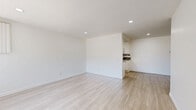 Located at 7833 Ventura Canyon Ave in the Panorama City neighborhood of Los Angeles, this single-story, 3-bedroom, 2-bathroom home offers a clean, modern aesthetic throughout. Light wood-style flooring runs consistently across the entire home, creating a cohesive and airy feel.

The kitchen is well-appointed with white cabinetry, granite countertops, a tile backsplash, stainless steel appliances including a gas range and built-in microwave, and track lighting overhead. The combined kitchen and living area provides a functional, open layout suited for everyday living.

The three bedrooms are bright and neutral, each featuring light walls, vertical-blind-covered windows that allow natural light to filter in, and light wood flooring. The primary bedroom includes a spacious built-in shelving unit and sliding glass door access. Additional bedrooms are fitted with sliding closets. The hallways feature mirrored sliding closet doors, adding depth and storage.

The two bathrooms are finished in white with granite-topped vanities and white cabinetry. Both include shower-tub combinations. One bathroom features wood-look flooring and open built-in shelving for added storage convenience. The overall design is clean, neutral, and move-in ready.