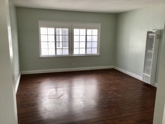 Living room with cherry hardwood floors throughout entirety of apartment - 7037 W Manchester Ave