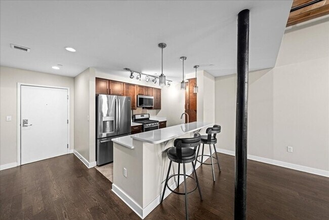 Building Photo - Stylish Industrial Loft with Exposed Brick, High Ceilings & Modern Kitchen