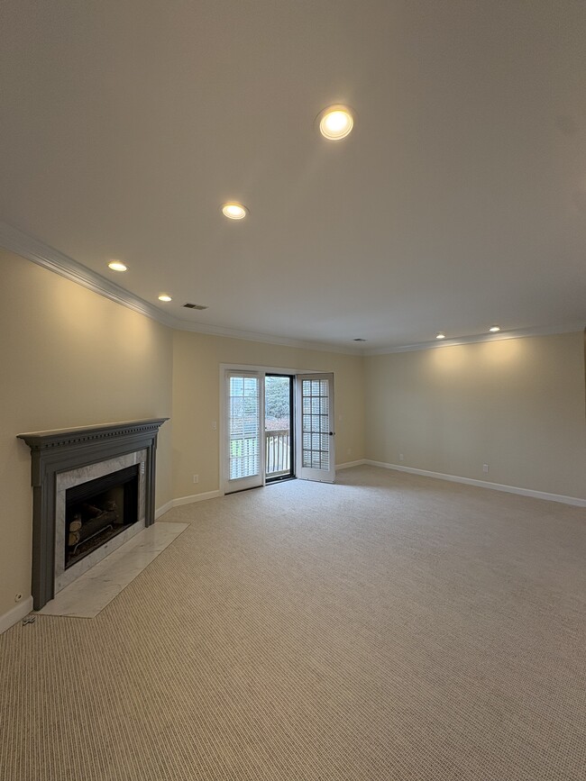 Living room with gas fireplace and Juliet balcony with recess lighting and ample natural light - 2032 Graybar Ln