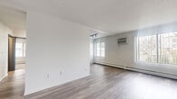 Located at 2044 Oakdale Ave in West St. Paul, MN, this single-level, three-bedroom, one-bathroom home offers a thoughtfully arranged floor plan across a compact and efficient footprint. The open living room features light luxury vinyl plank flooring, bright white walls, a textured ceiling, track lighting, a wall-mounted air conditioning unit, and baseboard heating — creating a clean, functional space filled with natural light from multiple windows. The updated kitchen is equipped with gray shaker-style cabinetry, white subway tile backsplash, white countertops, a stainless steel sink with a matte black faucet, and black appliances including a refrigerator and dishwasher. An in-unit stacked washer and dryer adds everyday convenience. The three bedrooms are carpeted for comfort, each featuring baseboard heat and natural light from windows with blinds. The primary bedroom includes a built-in closet with a sliding door, while another bedroom features an open closet with shelving. A dedicated walk-in closet with multi-tier shelving provides ample storage. The full bathroom is finished with LVP flooring, a gray vanity, and a full tub-shower combo with white surround. A hallway connects all rooms, completing this well-organized and move-in ready home.