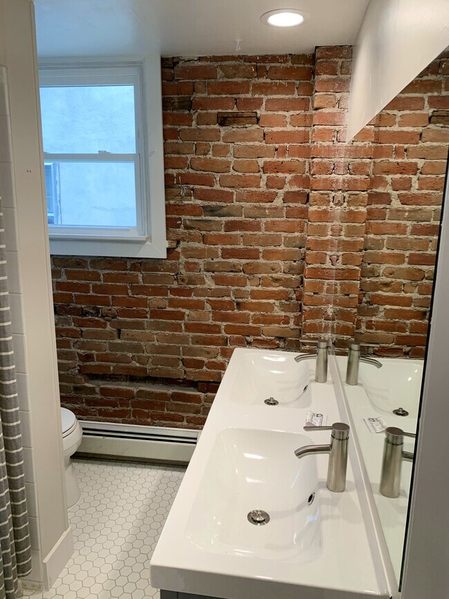 Updated bathroom with brick wall design! - 1638 Adams St