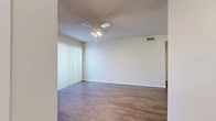 Located at 5101 Sanger Ave in Waco, Texas, this one-bedroom, one-bathroom unit offers a practical and well-organized single-floor layout. The living area greets you with durable wood-look flooring, neutral walls, and a ceiling fan with integrated lighting, creating a bright and comfortable atmosphere. Vertical blinds on the sliding door allow for adjustable natural light and easy access to the outdoors. The galley-style kitchen is efficiently arranged, featuring warm wood-toned cabinetry, a white electric range, a full-size refrigerator, and a countertop on both sides — providing ample prep space for everyday cooking. The bedroom is carpeted for warmth and comfort, equipped with its own ceiling fan and a window with blinds that lets in natural light. A dedicated walk-in closet with built-in shelving offers convenient and organized storage. The full bathroom is clean and straightforward, featuring a tiled shower-tub combo with a grab bar, a toilet, and a sink. The textured ceilings throughout add a classic residential character to the space. Overall, this unit provides a functional and comfortable living environment suited for individuals or couples seeking a well-appointed home in Waco.