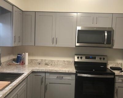 Kitchen with new cabinets, appliances and vinyl plank flooring - 145 Bard Dr