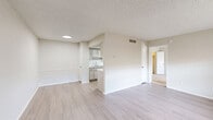 Located at 1655 Blue Bell Rd in Houston, TX, this one-bedroom, one-bathroom unit is laid out on a single floor with a functional and efficient design. The living room is bright and welcoming, featuring light wood-style vinyl flooring, recessed lighting, neutral-toned walls, and a large window that allows natural light to fill the space. The open layout connects seamlessly to the combined dining area and galley-style kitchen. The kitchen is equipped with gray shaker-style cabinetry, white countertops, a stainless steel electric range, a refrigerator, an overhead ventilation hood, and a single-basin sink — all beneath a skylight that adds additional brightness. A dedicated pantry provides extra storage. The spacious bedroom features plush wall-to-wall carpeting, a ceiling fan with light fixture, a window with blinds, and direct access to both a closet and the bathroom. The bathroom includes a full-size soaking tub with a tiled shower surround, chrome fixtures, and clean white finishes. Throughout the unit, textured ceilings and consistent neutral tones create a cohesive, move-in-ready atmosphere.