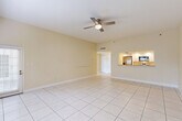 Located at 6415 21st Ave W in Bradenton, Florida, this single-story, 2-bedroom, 2-bathroom home offers a well-designed layout with consistent light-toned tile flooring throughout. The open-concept living and dining area is spacious and bright, featuring warm cream-colored walls and ceiling fans that enhance the comfortable Florida atmosphere. A pass-through counter connects this main living space to the kitchen, which is equipped with crisp white cabinetry, granite countertops, recessed lighting, and stainless steel appliances including a dishwasher and microwave — a clean, functional design suited for everyday use.

A central hallway provides access to both bedrooms and multiple closets, with an impressive total of six closets distributed throughout the home, offering exceptional storage capacity. The generously sized primary bedroom includes its own closet and ceiling fan. The bathrooms are finished with tile flooring, granite-topped vanities, and glass-enclosed showers. Natural light filters in through windows in the bedrooms and living areas, contributing to the home's airy feel. A dedicated laundry space adds further convenience. The overall design is practical, clean, and well-suited to Florida living.