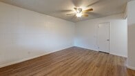 Located at 3765 N Campbell Ave in Tucson, Arizona, this single-floor unit offers a practical and well-organized layout across its living spaces. The main living area features warm wood-look vinyl flooring, textured ceilings, and a ceiling fan, creating a comfortable everyday environment. A large window allows natural light to fill the space, with vertical blinds providing privacy and light control.

The kitchen is efficiently designed in an L-shaped configuration, outfitted with light natural wood cabinetry, white appliances including a refrigerator, electric range, built-in microwave, and dishwasher, along with white countertops and a stainless steel sink. The kitchen flows naturally into the adjacent living and dining areas.

The bedrooms are carpeted for comfort and feature painted cinder block accent walls, textured ceilings, and windows with vertical blinds. One bedroom includes a ceiling fan and direct access to the bathroom, while another benefits from a large sliding glass door that invites additional natural light.

The bathroom is neatly appointed with a full tub and shower combination featuring wood-toned surround panels, a single-sink vanity with light wood cabinetry, white countertops, and wood-look flooring, offering a clean and functional finish throughout.