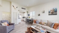 Located in Billings, Montana, this well-designed single-story, one-bedroom, one-bathroom home maximizes its compact footprint with a smart, open-concept layout. Light wood-style flooring flows consistently throughout every room, lending a cohesive and airy feel to the entire space.

The living room is bright and welcoming, benefiting from multiple windows that bring in abundant natural light and offer views of the surrounding neighborhood. The space opens directly into a combined dining area, making it ideal for both relaxing and entertaining.

The galley-style kitchen is efficiently laid out with white cabinetry, dark countertops, stainless steel appliances, and a door providing direct exterior access. Ample cabinet storage and counter space make the kitchen highly functional despite its streamlined form.

The bedroom is comfortably sized, featuring a large window that fills the room with natural light. A sliding barn-style closet door adds a contemporary touch, while the layout accommodates both sleeping and additional use areas with ease.

The bathroom is clean and well-appointed, with white cabinetry, dark countertops, a tub-shower combination, and in-unit laundry access conveniently nearby.

Throughout the home, crisp white walls and recessed lighting contribute to a bright, neutral palette, creating a versatile and move-in-ready living environment in the heart of Billings, MT.