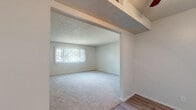 Located at 7520 W Amherst Ave in Denver, CO, this single-floor unit offers three bedrooms, two bathrooms, a kitchen, a closet, and a connecting hallway in a well-organized layout. The bedrooms feature soft wall-to-wall carpeting and textured ceilings, with natural light entering through windows dressed in vertical blinds. The spacious primary bedroom includes dual mirrored sliding closets, adding both storage and a sense of openness. The two additional bedrooms are comfortably sized, each with mirrored closet doors and neutral tones throughout. Both bathrooms are clean and functional, each equipped with a full tub and shower combination — one featuring classic white square tile surround and the other a smooth panel surround, both with chrome fixtures. The kitchen is bright and efficient, showcasing white cabinetry, light granite-style countertops, a double stainless steel sink, and wood-look flooring that contrasts nicely with the carpeted living areas. A large window over the kitchen sink brings in natural light and outdoor views of the surrounding neighborhood. The overall aesthetic is clean, neutral, and move-in ready, making this Denver unit a practical and comfortable place to call home.