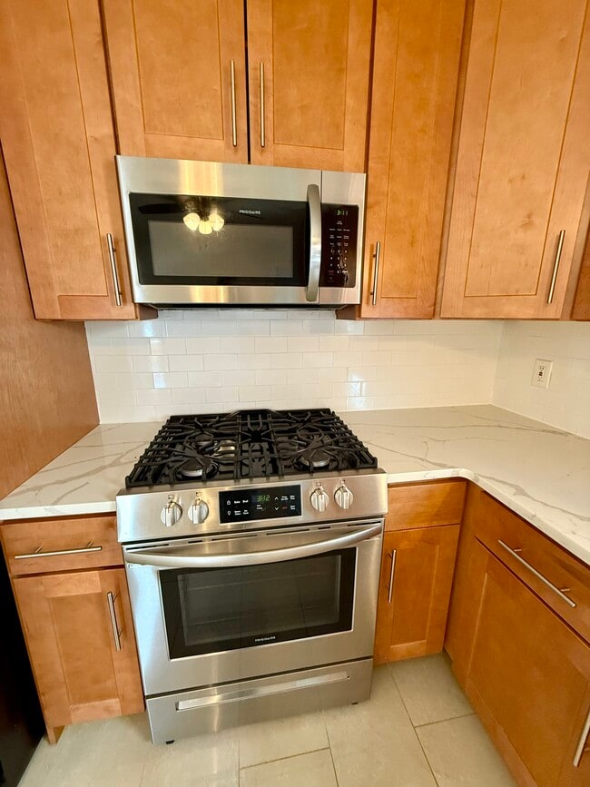 Updated kitchen with quartz counters and stainless steel appliances - 60 Baltimore Ave