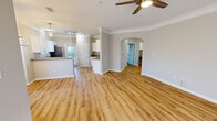 Located at 2000 Central Parkway in Montgomery, Alabama, this well-appointed 2-bedroom, 2-bathroom single-floor residence offers a thoughtfully designed open-concept layout. The spacious living area greets you with warm hardwood-style flooring, elegant crown molding, and a ceiling fan, creating a bright and airy atmosphere enhanced by abundant natural light streaming through multiple windows. An elegant arched passageway connects the main living area to the private bedroom wing.

The kitchen features crisp white cabinetry, granite countertops, stainless steel appliances including a refrigerator, and a peninsula that opens to the living space. A door from the kitchen provides convenient outdoor access.

Both bedrooms are generously sized, finished with plush carpeting, ceiling fans, and windows that frame outdoor greenery. The primary bedroom is particularly spacious and is served by an ensuite bathroom complete with granite countertops, white cabinetry, and a well-lit vanity mirror. A walk-in closet with wire shelving provides ample storage.

The dedicated laundry room houses a full-size side-by-side washer and dryer. Two hallways efficiently connect all areas of the home, ensuring a smooth and functional flow throughout this comfortable and modern residence.