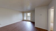 Located at 1401 Saint Edwards Drive in Austin, TX, this one-bedroom, one-bathroom unit offers a practical and well-organized single-floor layout. The living room is a welcoming, open space finished with rich wood-style flooring and neutral walls, with large windows allowing generous natural light and outdoor views of the surrounding greenery. A ceiling fan with a light fixture enhances airflow and comfort throughout.

The kitchen features an L-shaped layout with white cabinetry, open shelving, a gas range, refrigerator, dishwasher, and a double-basin sink — all finished in a clean, all-white palette with light wood-style flooring. The space is efficiently designed to maximize functionality.

The bedroom is carpeted for comfort and includes two separate closets, providing ample storage. A ceiling fan with light adds practicality, and a window brings in natural light. The full bathroom is clean and straightforward, featuring a tub/shower combo with tiled surround, a toilet, and light wood-style flooring.

Throughout the unit, textured ceilings and neutral tones create a cohesive, low-maintenance aesthetic. The overall layout is efficient, making excellent use of the available footprint for comfortable everyday living in the heart of Austin's 78704 corridor.