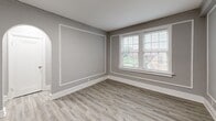 Located at 5345 Cabanne Ave in St. Louis, MO, this 2-bedroom, 1-bathroom residence offers a thoughtfully designed layout across a single floor. Light wood-style flooring flows consistently throughout the space, complemented by neutral gray walls and crisp white trim, creating a clean and cohesive aesthetic.

The kitchen is well-equipped with gray shaker-style cabinetry, granite-look countertops, a gas range, and a subway tile backsplash. Natural light enters through a window above the counter, and a door provides convenient exterior access.

The living room is a standout space, featuring elegant wall molding details and a graceful arched doorway that adds architectural character. Large windows allow generous natural light and neighborhood views, enhancing the room's openness.

Both bedrooms are comfortably sized, with the primary bedroom offering notable square footage. Each room benefits from natural light via well-positioned windows with outdoor views of the surrounding neighborhood.

A narrow hallway connects the bedrooms to the full bathroom, which is a visual highlight of the home. It features floor-to-ceiling blue-gray subway tile surrounding the tub and shower, chrome fixtures, a white vanity, and a gridded window that brings in soft natural light, creating a bright and stylish retreat.