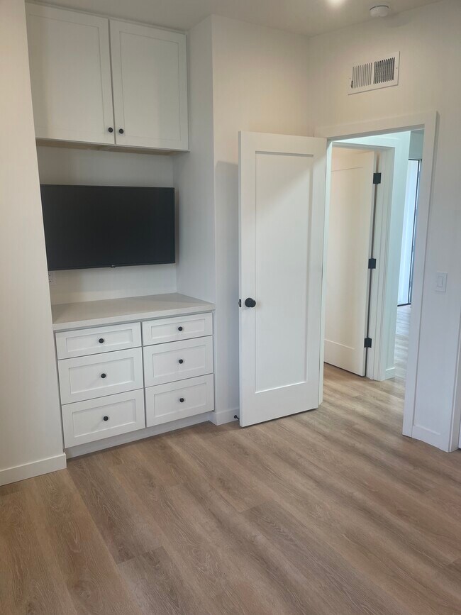Bedroom with TV and built-in dresser. - 747 Vasques Dr