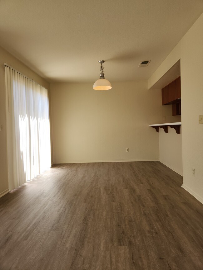 Dining room with new LVP & attached patio - 9502 Walker St
